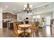 Open concept kitchen, living, and dining area, with hardwood floors and modern lighting offering a seamless living experience at 420 Retreat Ln, Wake Forest, NC 27587