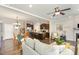 Open-concept living space showcasing a modern kitchen, dining area, and a comfortable living room with fireplace at 420 Retreat Ln, Wake Forest, NC 27587