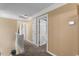 Upstairs hallway featuring neutral paint, carpet, white doors, and access to other rooms at 4225 Old Lewis Farm Rd, Raleigh, NC 27604