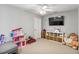 Playful bedroom featuring toys, a TV, a ceiling fan, and a storage unit at 4429 Gallatree Ln, Raleigh, NC 27616