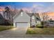 Charming two-story home featuring stone accents, manicured landscaping, and a two-car garage at 4429 Gallatree Ln, Raleigh, NC 27616