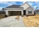 Charming single-Gathering home with a two-car garage, gray siding, and a well-manicured lawn at 46 Rolling Banks Dr, Louisburg, NC 27549