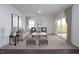 Bright living room with stylish furnishings, neutral carpet, and sliding doors to the outdoor space at 46 Rolling Banks Dr, Louisburg, NC 27549