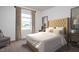 Cozy bedroom with a comfortable bed, stylish nightstands, neutral carpet, and natural light from the window at 46 Rolling Banks Dr, Louisburg, NC 27549