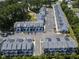 Birds eye view of townhomes nestled among trees, featuring a small pond at 4810 Gossamer Ln # 105, Raleigh, NC 27616