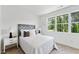 Bright bedroom featuring a comfortable bed, side tables with lamps, and a large, bright window at 4810 Gossamer Ln # 105, Raleigh, NC 27616