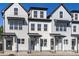 Modern townhome exteriors featuring black accents, light-colored siding, and stylish entryways create an appealing look at 4810 Gossamer Ln # 105, Raleigh, NC 27616