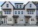 Charming townhome exteriors feature light colors, black trim, and covered entryways, creating a welcoming curb appeal at 4810 Gossamer Ln # 105, Raleigh, NC 27616