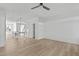Open living space with hardwood floors, fan, and kitchen island at 4810 Gossamer Ln # 105, Raleigh, NC 27616