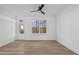 Spacious living room with hardwood floors, fan, and natural lighting at 4810 Gossamer Ln # 105, Raleigh, NC 27616