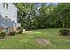Large backyard with lush lawn and mature trees providing shade at 4905 Will-O-Dean Rd, Raleigh, NC 27616