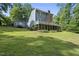 Home featuring a spacious backyard, a deck, and wooded boundary at 4905 Will-O-Dean Rd, Raleigh, NC 27616
