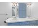 Bathroom features a double vanity, storage cabinet, and a mirror at 4905 Will-O-Dean Rd, Raleigh, NC 27616