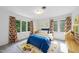 Charming bedroom with a blue bed, large windows providing natural light, and playful decor for a cozy feel at 4905 Will-O-Dean Rd, Raleigh, NC 27616