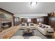 Spacious recreation room featuring a fireplace, wood paneling, neutral furniture and a modern ceiling light at 4905 Will-O-Dean Rd, Raleigh, NC 27616