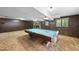 Spacious game room featuring a pool table, carpeted floors, brick fireplace and paneled walls at 4905 Will-O-Dean Rd, Raleigh, NC 27616