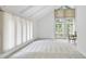 Bright living room with vaulted ceilings, large windows, and neutral carpet, creating a spacious and airy atmosphere at 4905 Will-O-Dean Rd, Raleigh, NC 27616