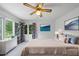 Calm primary bedroom featuring a large bed, blue and white accents, natural light, and pleasant decor at 4905 Will-O-Dean Rd, Raleigh, NC 27616