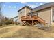 Backyard featuring a wooden deck, garden beds, and a spacious lawn leading up to the home at 5012 Trembath Ln, Cary, NC 27519