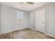 This bedroom has neutral colored walls, hardwood floors, a ceiling fan and a window for natural light at 513 Woods St, Durham, NC 27703