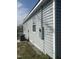 Exterior angle view of house with gray siding and electrical box at 513 Woods St, Durham, NC 27703