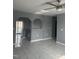 Open-concept living area featuring white tile flooring, stylish arches, and view of kitchen at 513 Woods St, Durham, NC 27703