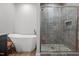 Bright bathroom with soaking tub, walk-in shower, and modern fixtures at 5507 Eagles Nest Trl, Snow Camp, NC 27349