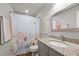 Colorful bathroom with floral shower curtain, granite countertop, and decorative mirror at 5507 Eagles Nest Trl, Snow Camp, NC 27349