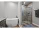 Modern bathroom featuring a soaking tub and glass-enclosed shower with pebble flooring at 5507 Eagles Nest Trl, Snow Camp, NC 27349
