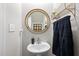 Powder room with pedestal sink, gold mirror, and decorative accents at 5507 Eagles Nest Trl, Snow Camp, NC 27349