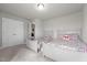 Bright bedroom with two beds featuring floral comforters and large closet space at 5507 Eagles Nest Trl, Snow Camp, NC 27349