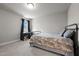Cozy bedroom featuring a black metal frame bed and a desk with natural light at 5507 Eagles Nest Trl, Snow Camp, NC 27349