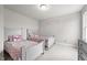Shared bedroom showcasing twin beds, carpet flooring, and gray walls at 5507 Eagles Nest Trl, Snow Camp, NC 27349