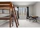 Bright bedroom featuring a loft bed, desk, and natural light from the large windows at 5507 Eagles Nest Trl, Snow Camp, NC 27349