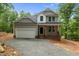 Charming two-story home featuring a covered front porch, two car garage and classic gray siding at 5507 Eagles Nest Trl, Snow Camp, NC 27349