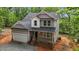 Charming two-story home featuring a covered front porch, two car garage and classic gray siding at 5507 Eagles Nest Trl, Snow Camp, NC 27349
