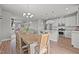 Open-concept kitchen and dining area with granite countertops, stainless steel appliances, and ample seating at 5507 Eagles Nest Trl, Snow Camp, NC 27349