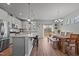 Modern kitchen with stainless steel appliances, a large island, and an adjacent dining area, perfect for entertaining at 5507 Eagles Nest Trl, Snow Camp, NC 27349
