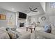 Bright living room with a fireplace, large TV, and neutral colors providing a relaxing atmosphere at 5507 Eagles Nest Trl, Snow Camp, NC 27349