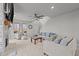 Cozy living room with a fireplace, comfortable seating, and views of the front yard through large windows at 5507 Eagles Nest Trl, Snow Camp, NC 27349