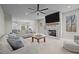 Open-concept living room featuring a fireplace, ceiling fan, and views into the kitchen and dining area at 5507 Eagles Nest Trl, Snow Camp, NC 27349