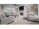Spacious living room with a brick fireplace, large TV, and ample seating for entertaining guests at 5507 Eagles Nest Trl, Snow Camp, NC 27349