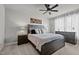 Comfortable main bedroom features a ceiling fan, large bed, and and dressers at 5507 Eagles Nest Trl, Snow Camp, NC 27349