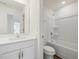 Bright bathroom featuring a vanity with a white countertop and a tub-shower combination at 553 Winding Creek Dr, Lillington, NC 27546