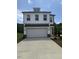 Charming two-story home with a white exterior, a two-car garage, and a well-manicured lawn at 553 Winding Creek Dr, Lillington, NC 27546
