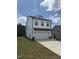 Attractive two-story home featuring white siding, well-kept lawn, and attached two car garage at 553 Winding Creek Dr, Lillington, NC 27546