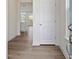 Inviting hallway with wood floors and a peek into the bright, modern kitchen at 553 Winding Creek Dr, Lillington, NC 27546