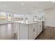 Bright, open kitchen with a large island, stainless appliances, and lots of natural light at 553 Winding Creek Dr, Lillington, NC 27546