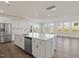 Modern kitchen with stainless appliances, large island, and hardwood floors, perfect for entertaining at 553 Winding Creek Dr, Lillington, NC 27546