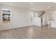 Spacious, light-filled living room featuring pristine white walls and beautiful hardwood floors at 553 Winding Creek Dr, Lillington, NC 27546